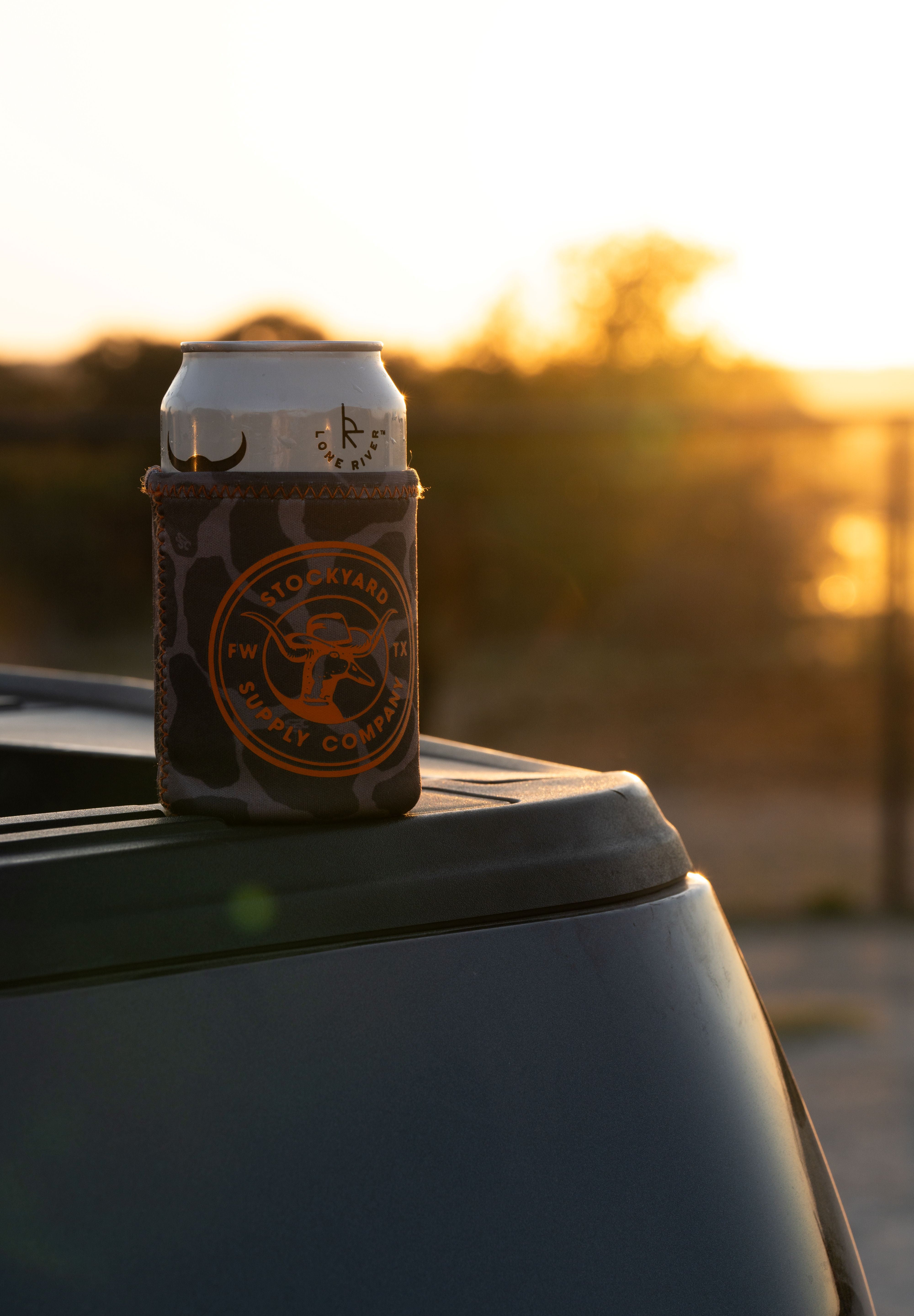 Duckster logo side of the coozie on a tailgate 