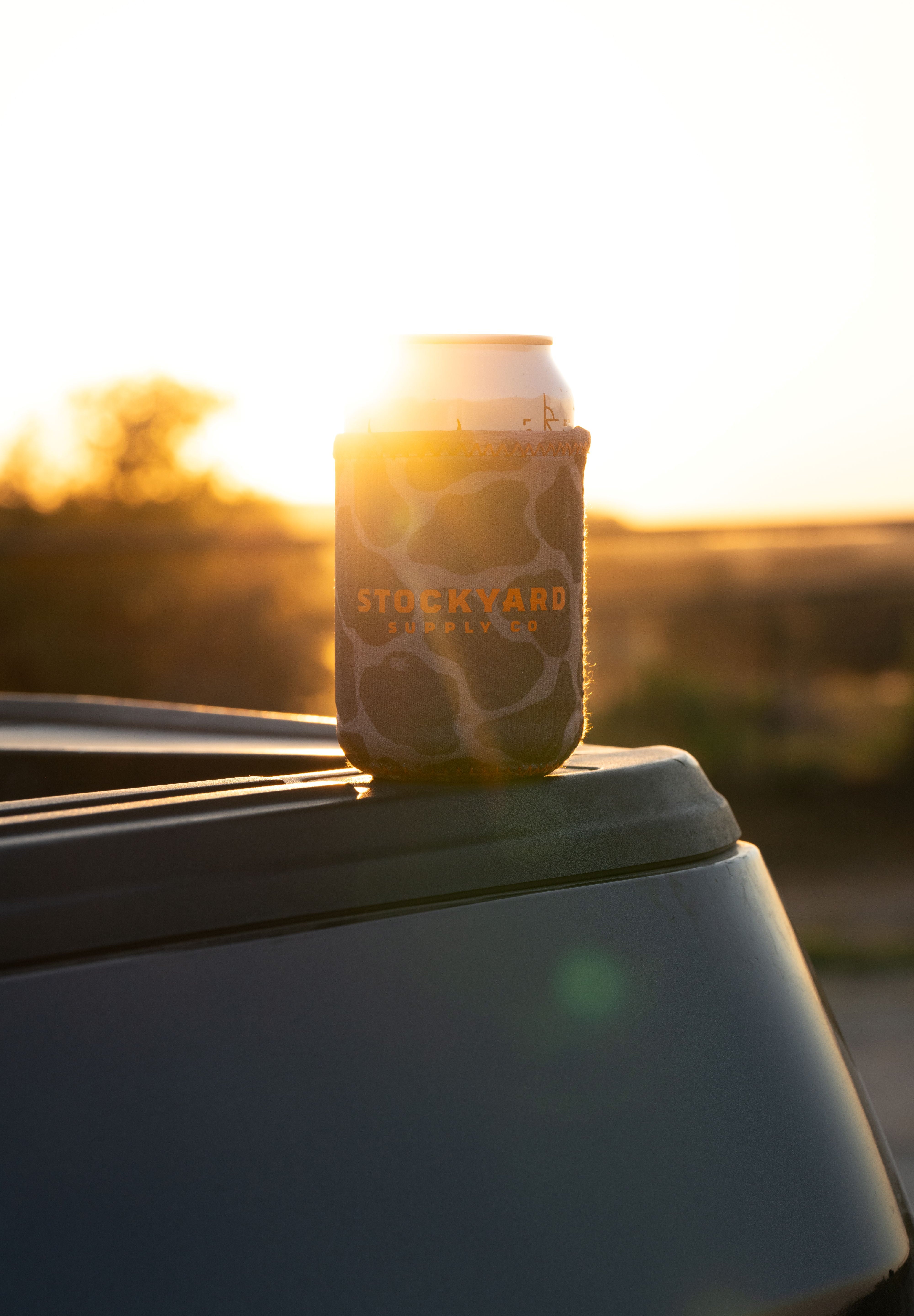 Camo Coozie with Stockyard Supply Co brand centered