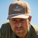 Eric Nelsen wearing the Coyote colored Champion hat and faded olive long sleeve performance pearl snap. 